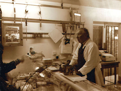 One of the owners proudly standing in their butcher shop