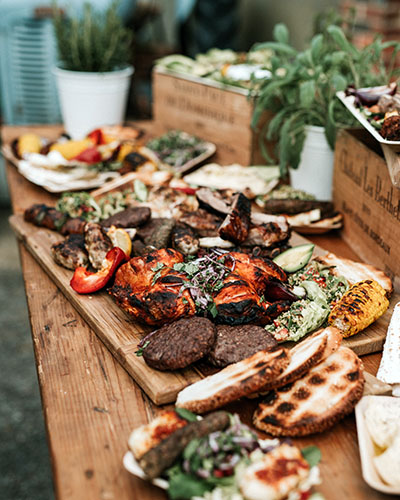 Image of variety of roasted peppers, corn on the cob, bread