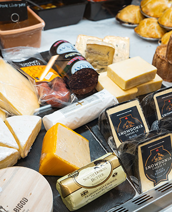 Artisanal deli display with a selection of cheeses